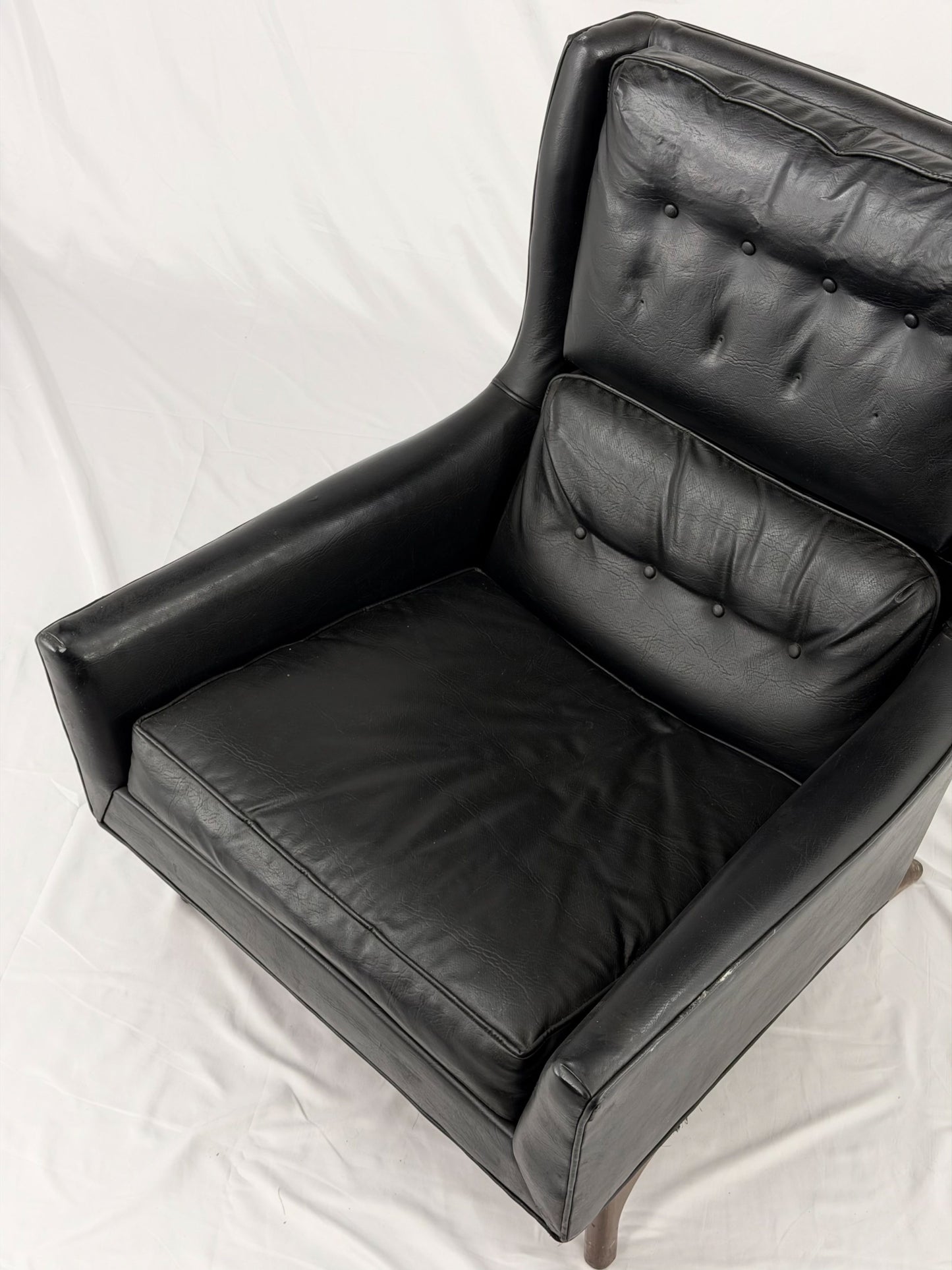 Black leather armchair on a white background