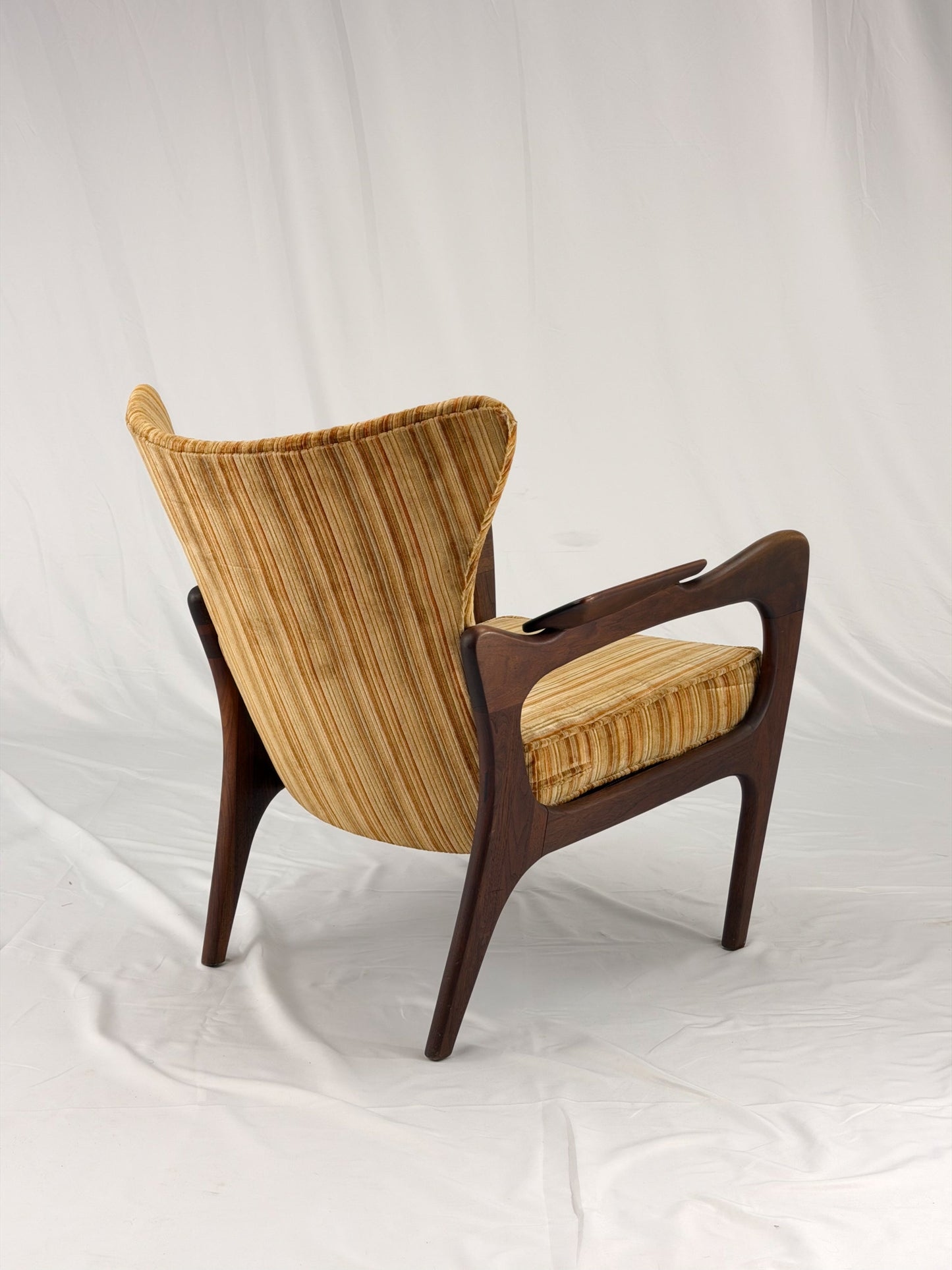 Adrian Pearsall armchair with striped upholstery on a white background