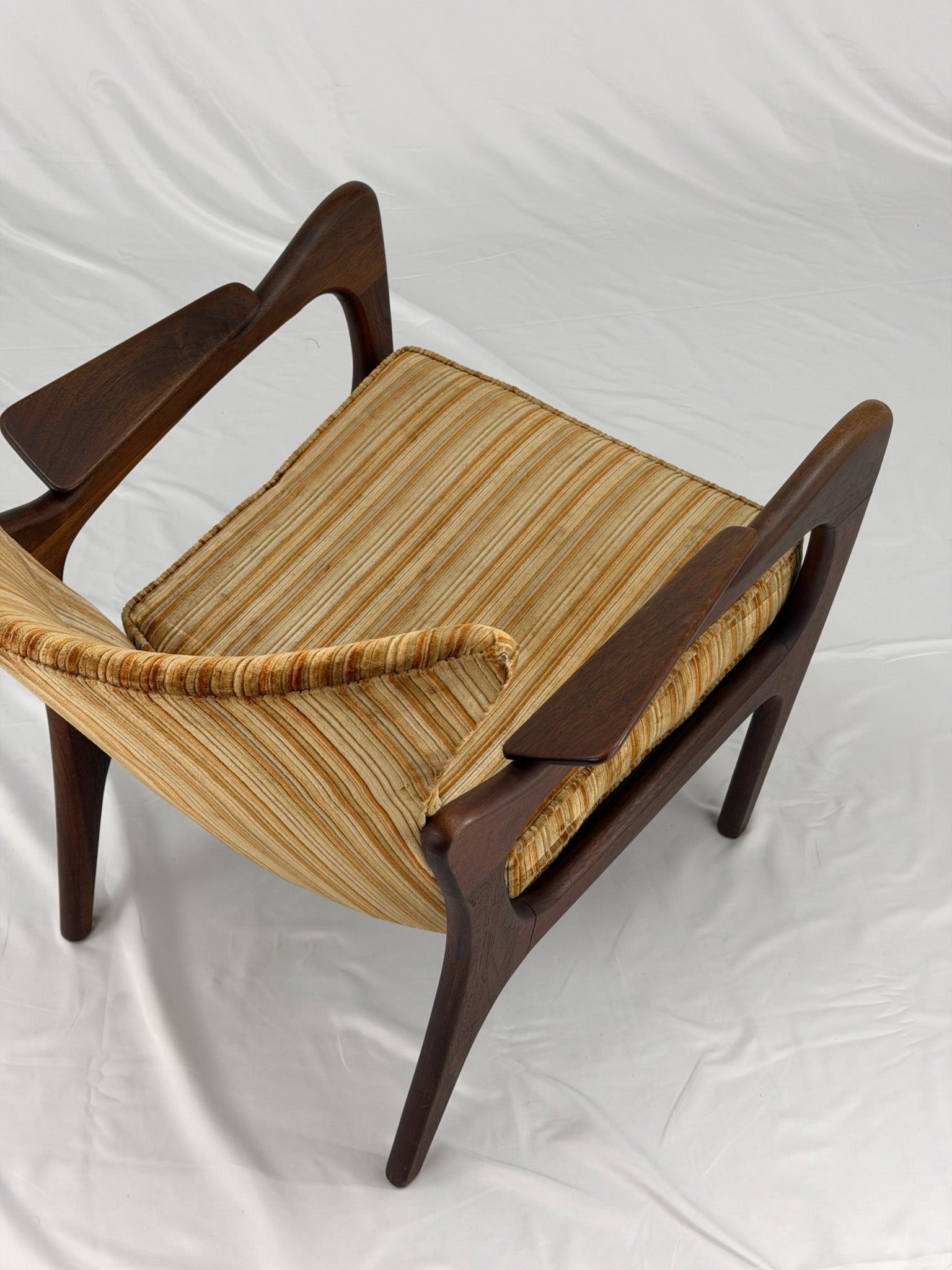 Adrian Pearsall armchair with striped upholstery on a white background