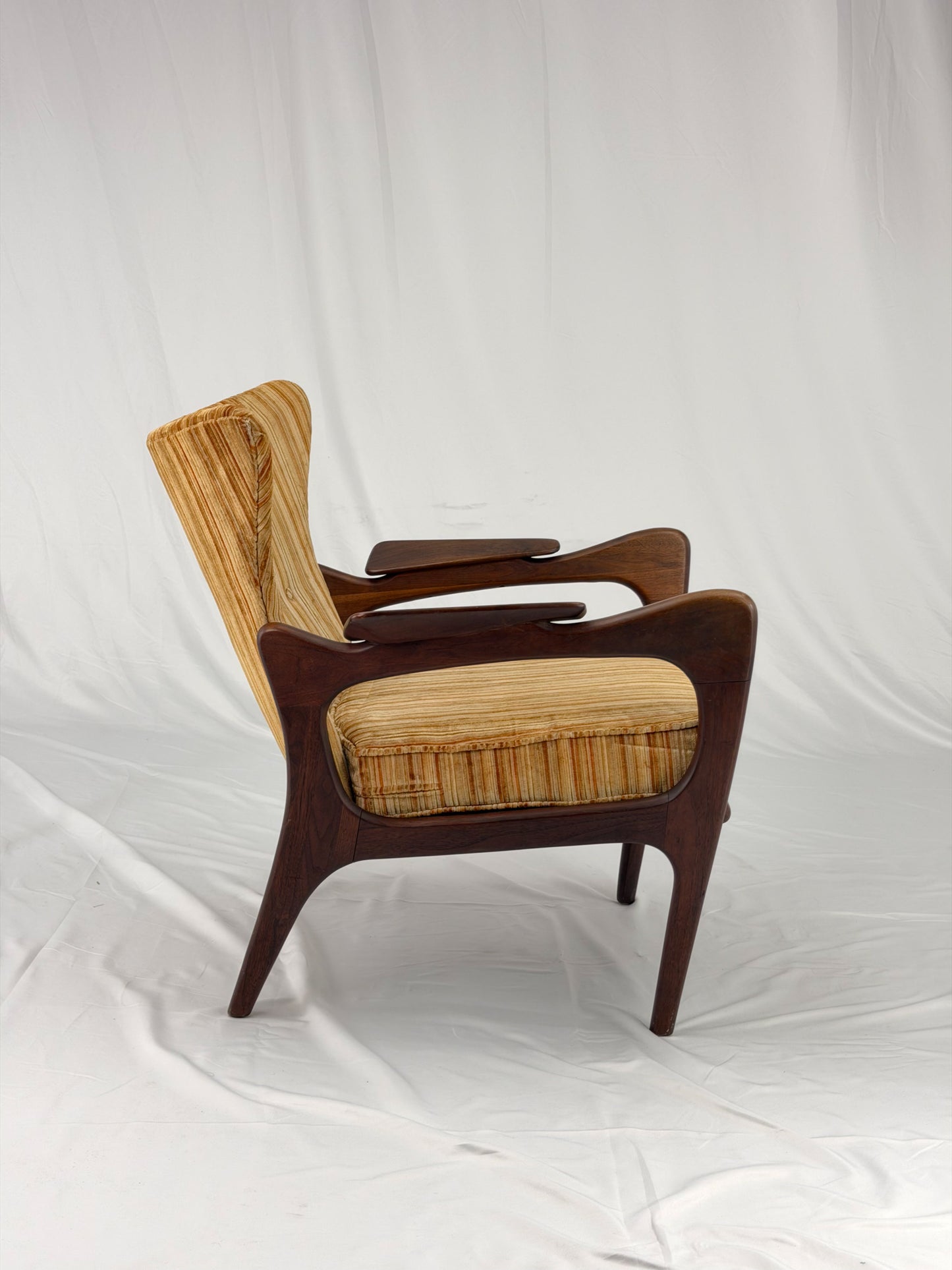 Adrian Pearsall armchair with striped upholstery on a white background