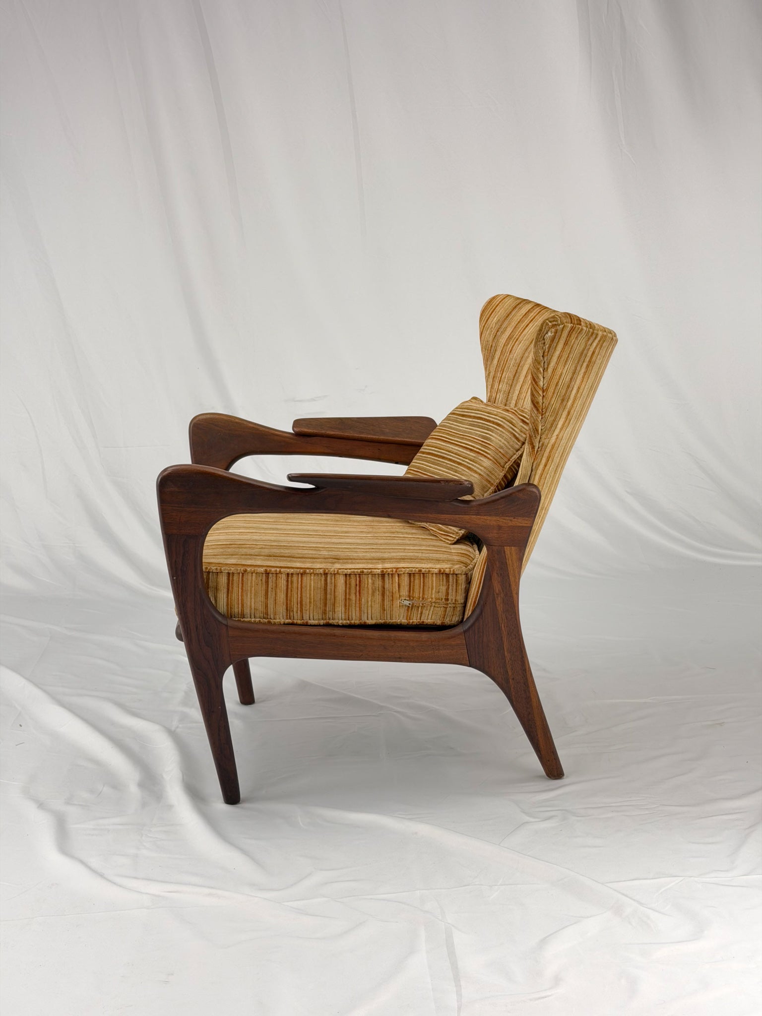 Adrian Pearsall armchair with striped upholstery on a white background