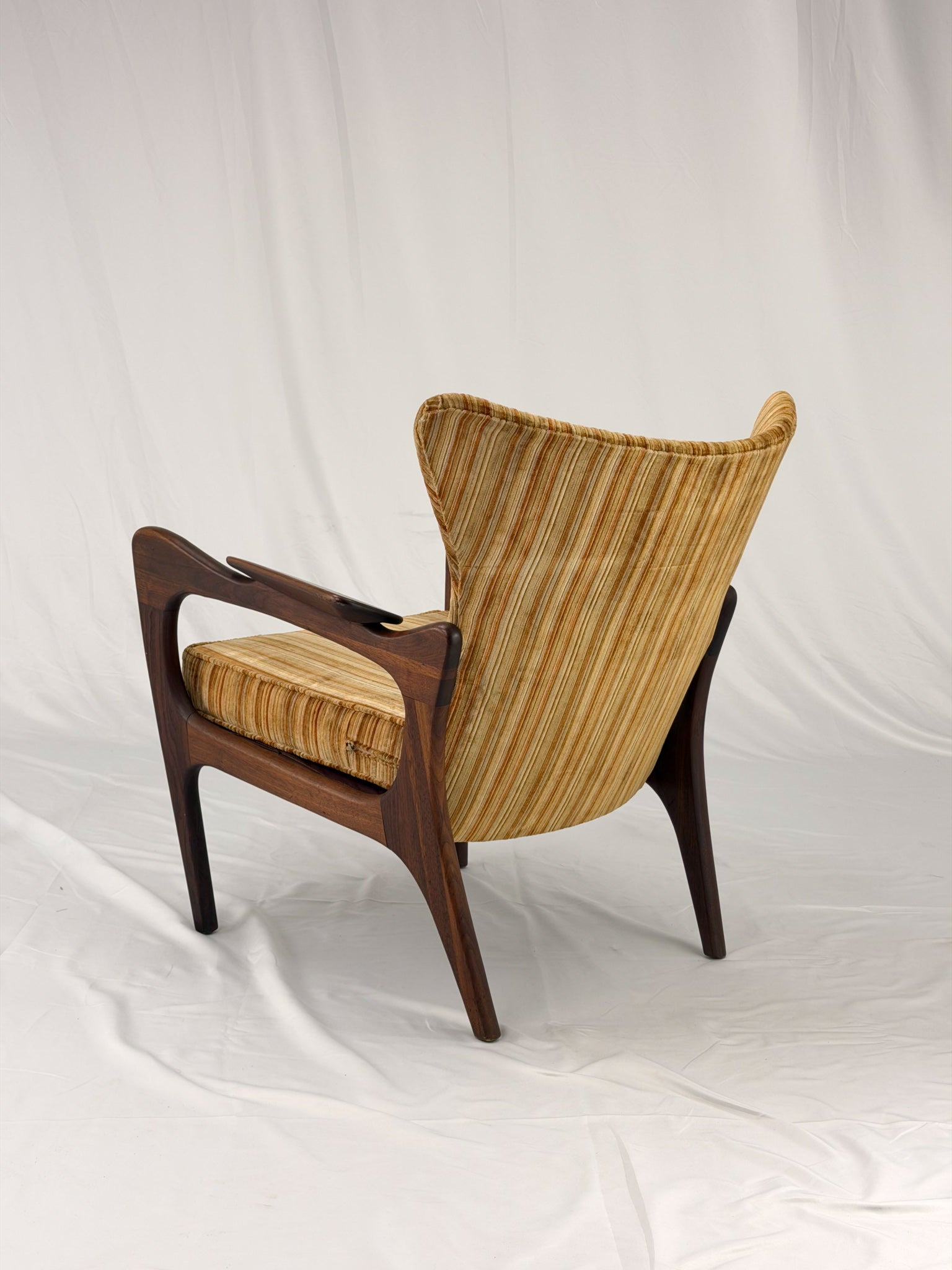 Adrian Pearsall armchair with striped upholstery on a white background