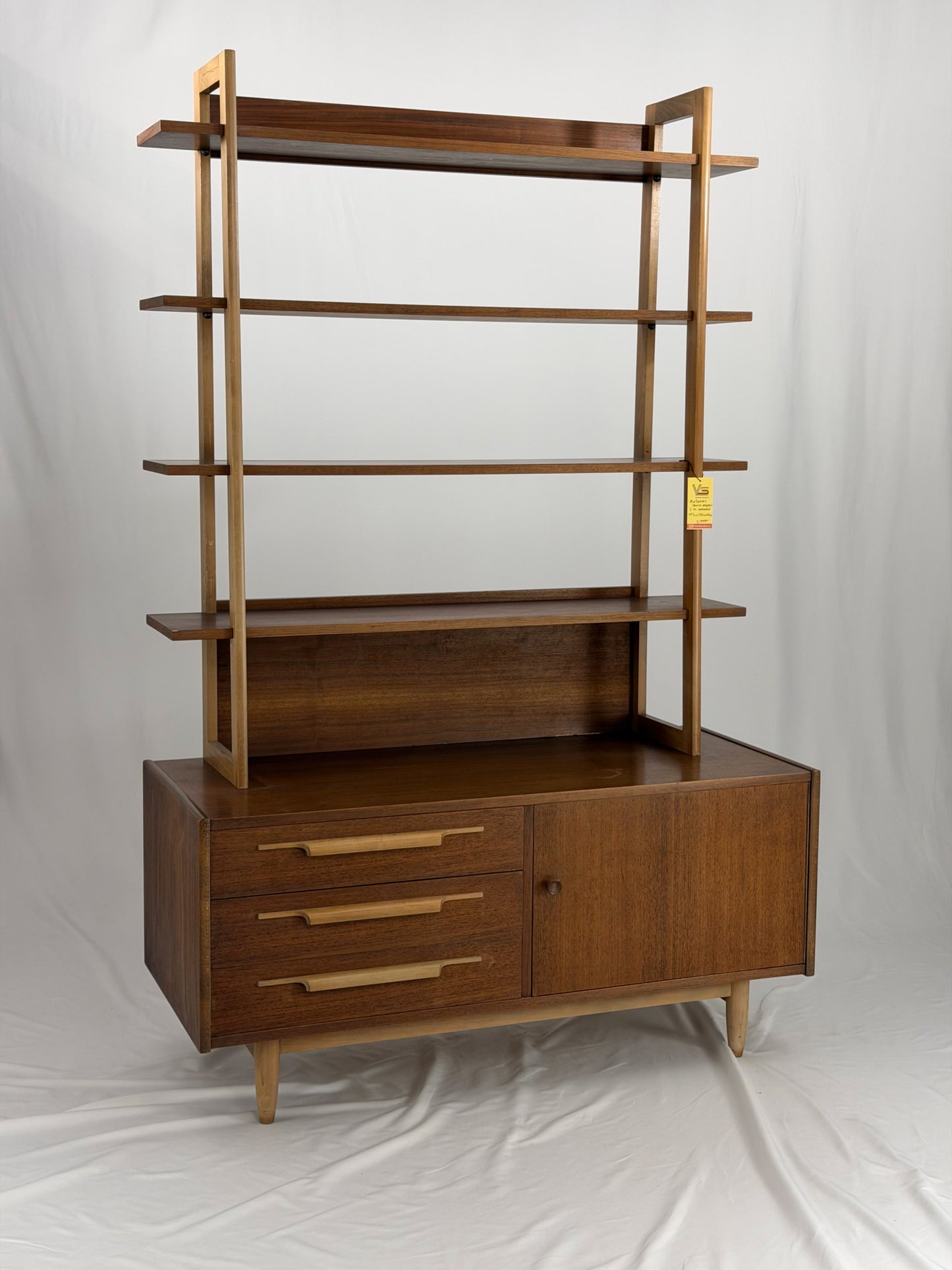 Wooden bookshelf with multiple shelves on a white background