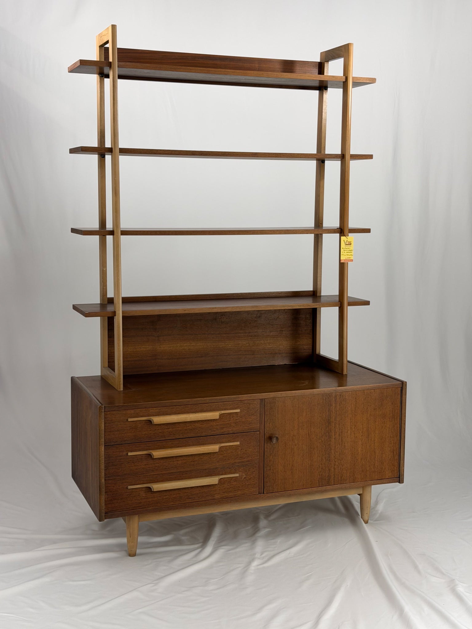 Wooden bookshelf with multiple shelves on a white background
