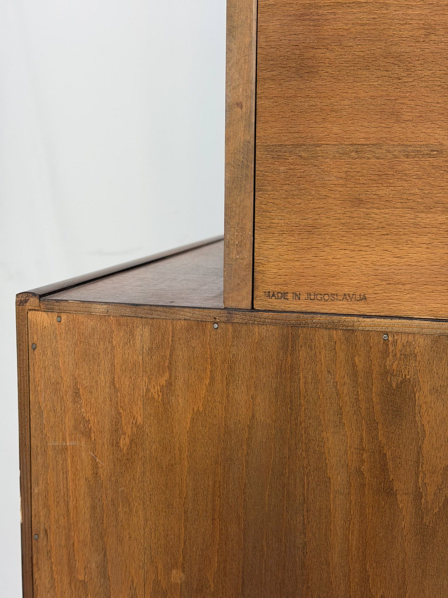 Wooden cabinet with 'Made in Yugoslavia' inscription on a white background