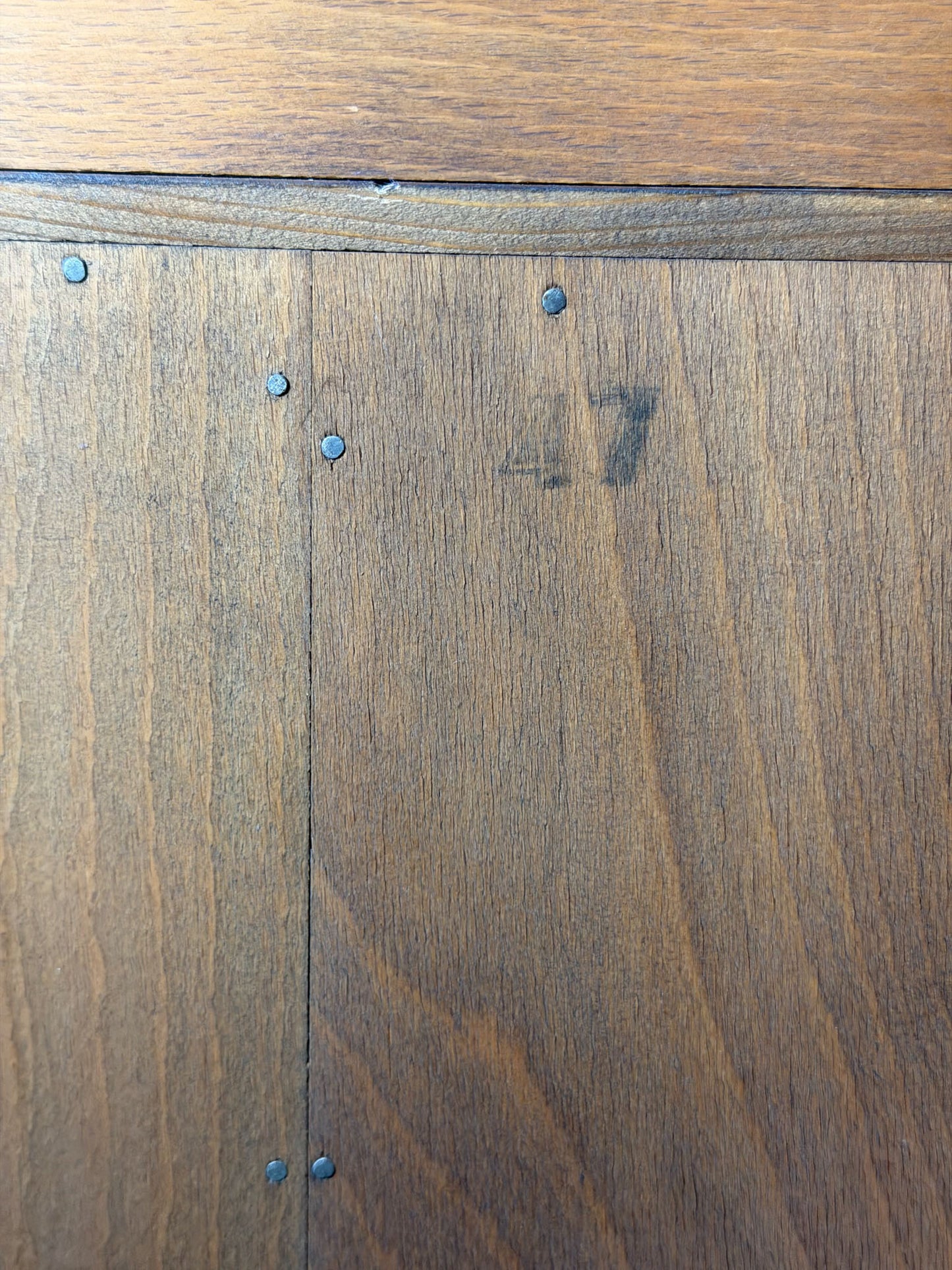 Close-up of wooden flooring with visible grain and slight imperfections.