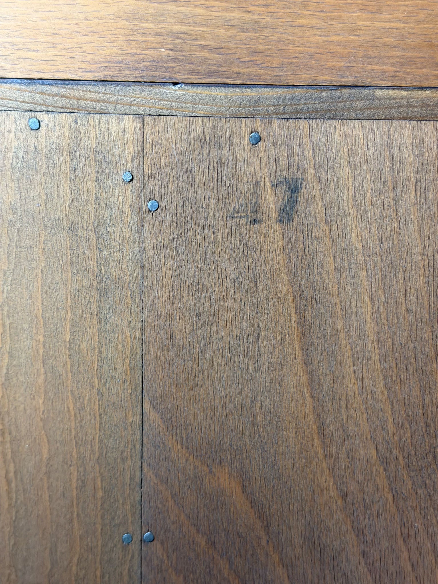 Close-up of wooden flooring with visible grain and slight imperfections.