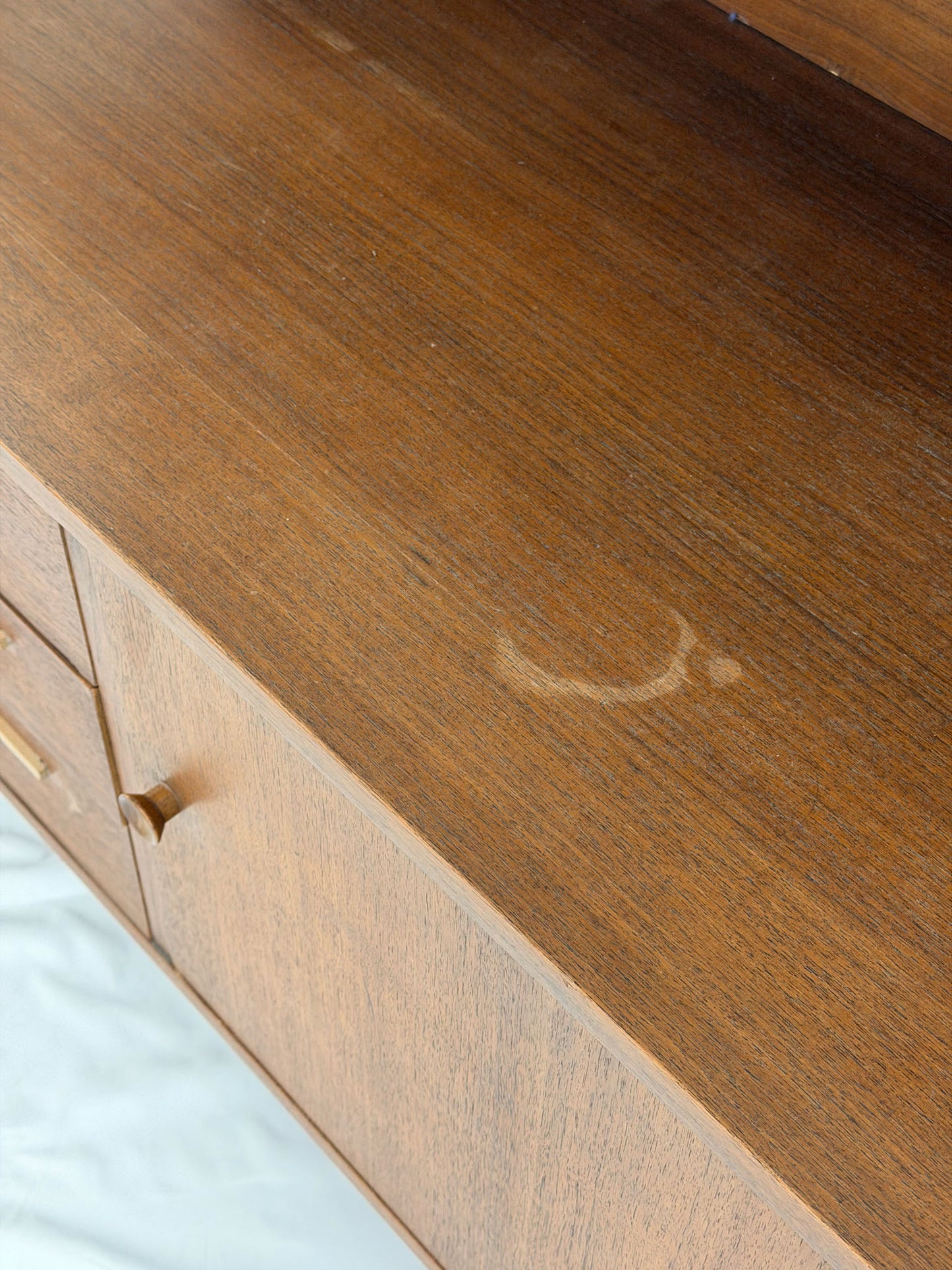 Wooden dresser with a visible scratch on the surface