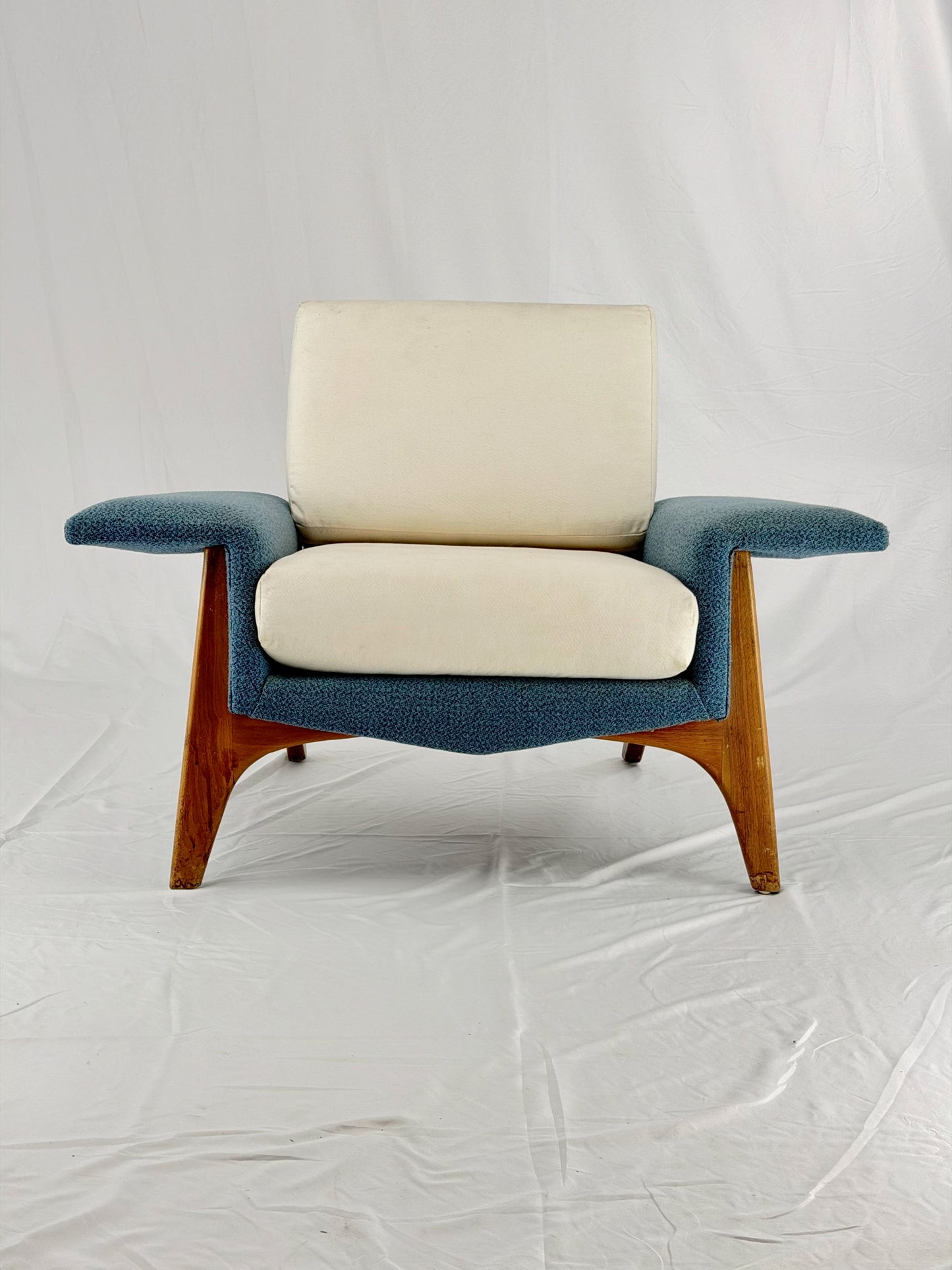 Chair with blue frame and beige cushion on a white background