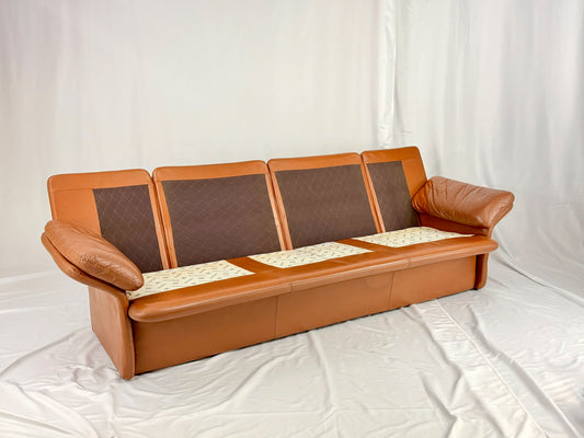 Brown leather sofa with brown cushions on a white background