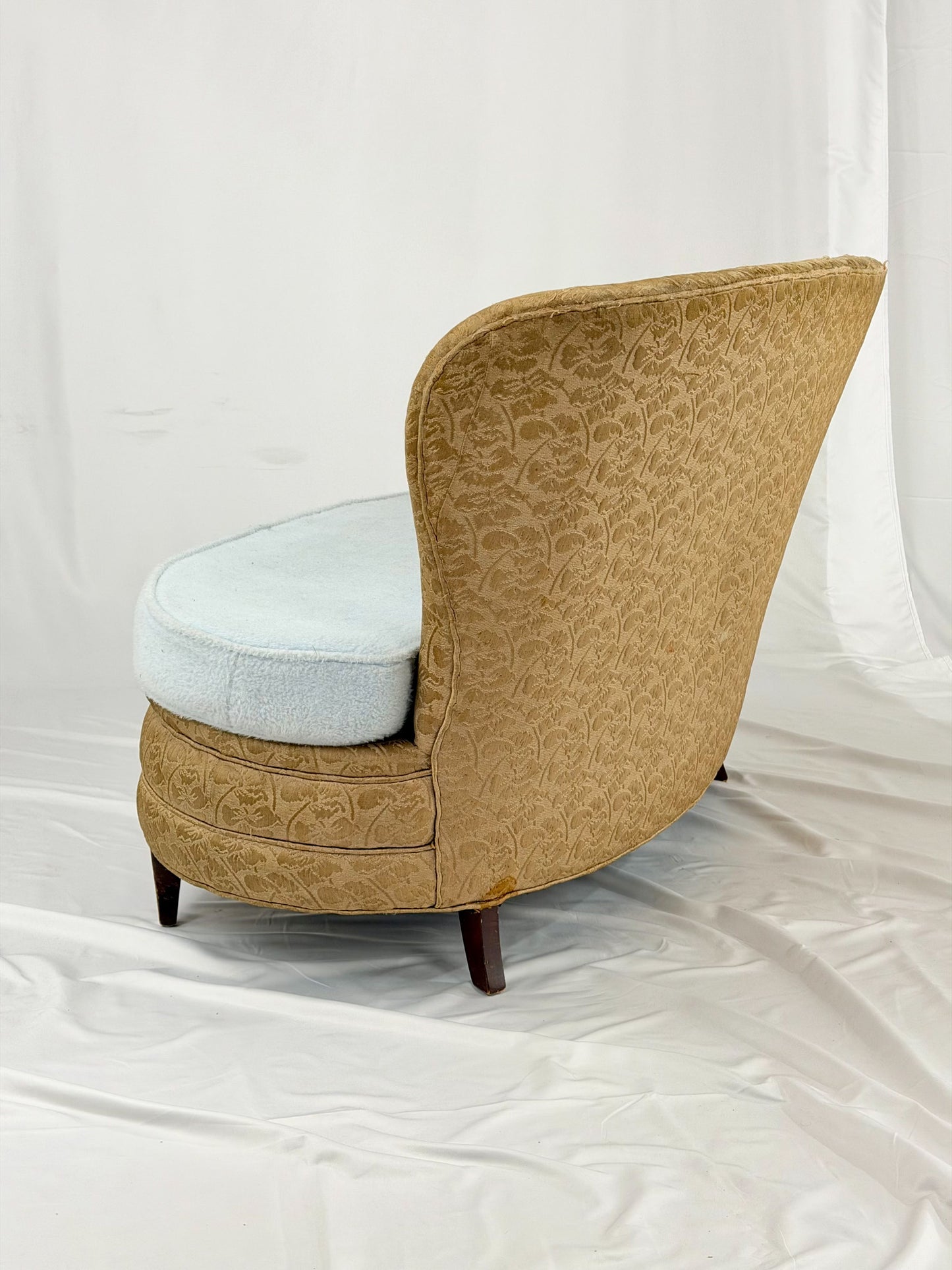 Antique settee with a light blue cushion on a white background