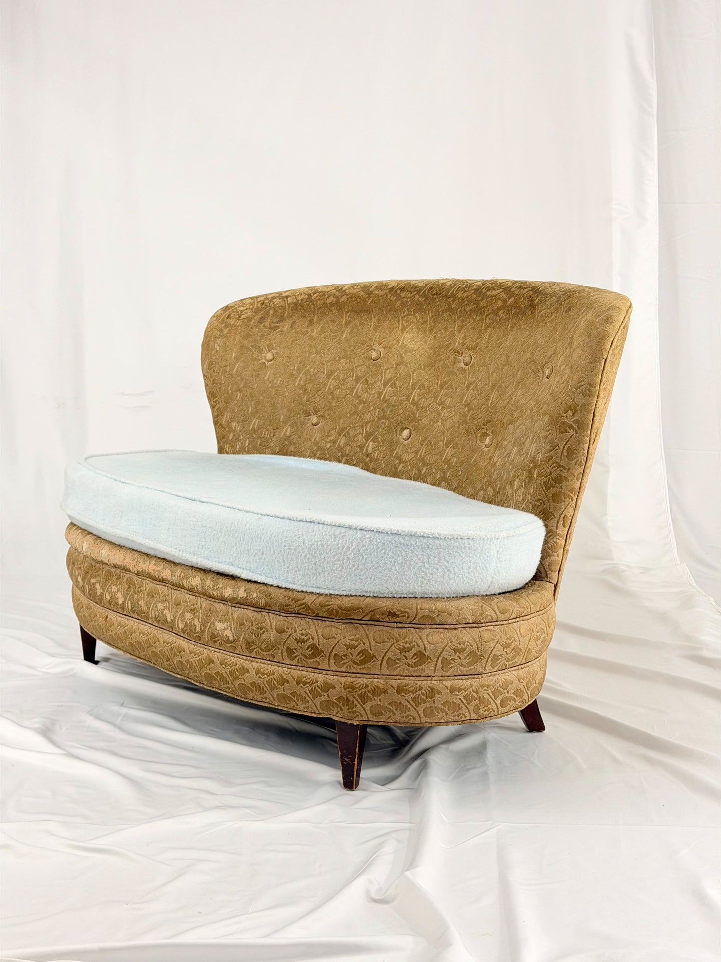 Antique settee with a light blue cushion on a white background
