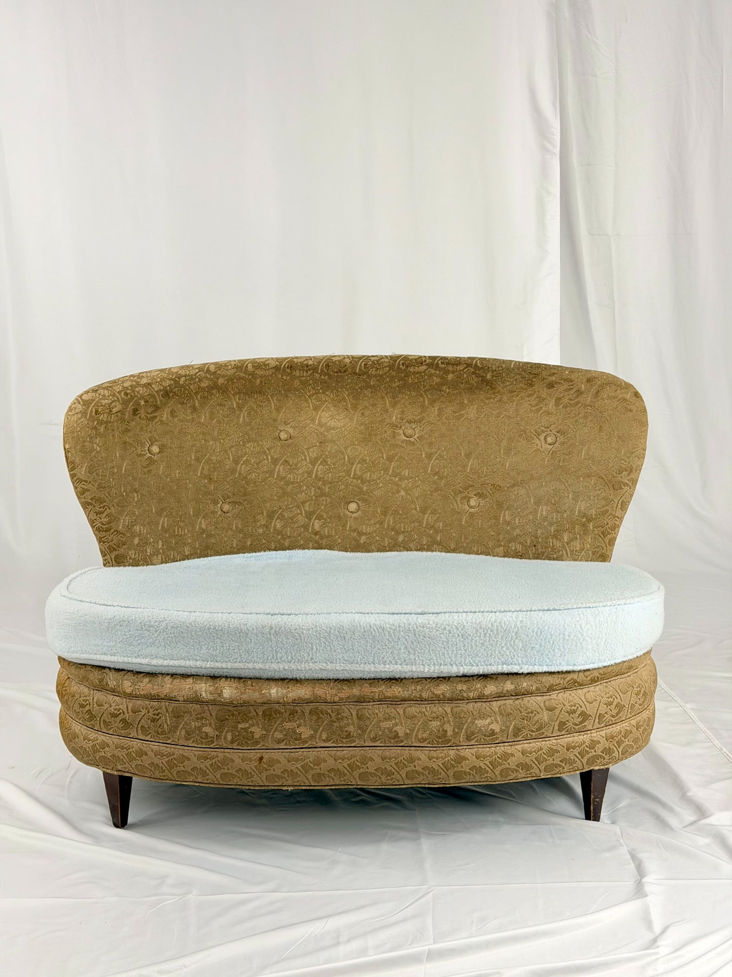Antique settee with a light blue cushion on a white background