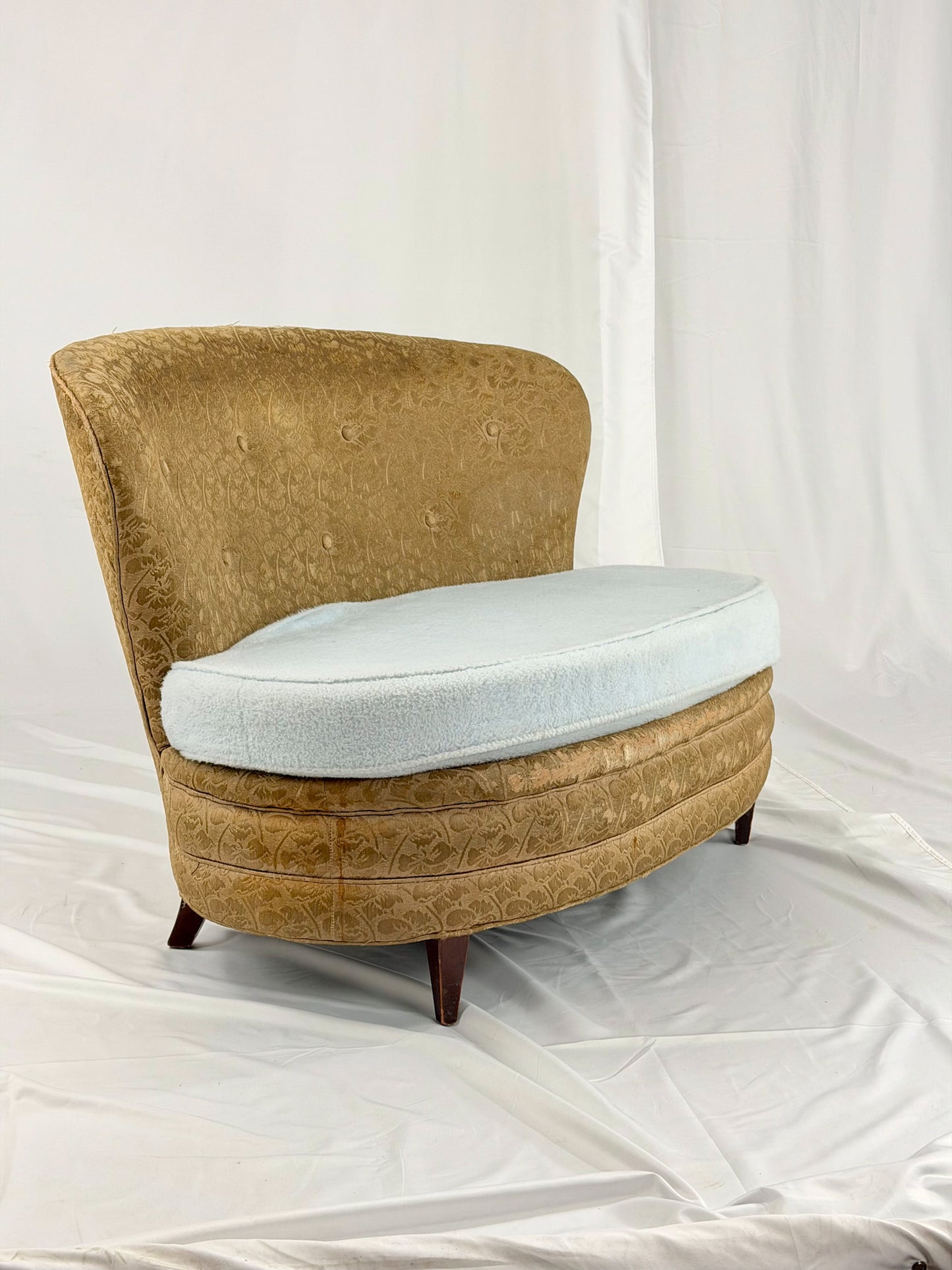 Antique settee with a light blue cushion on a white background