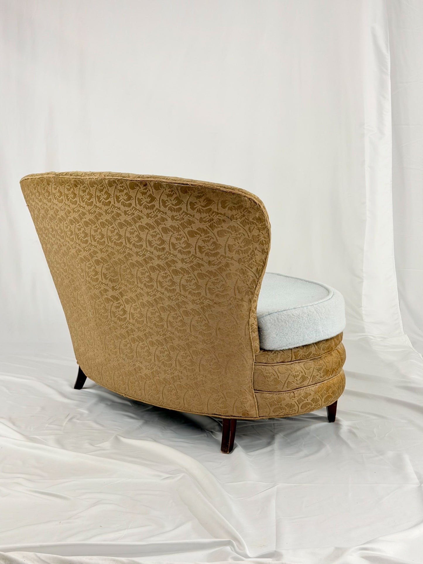 Antique settee with a light blue cushion on a white background